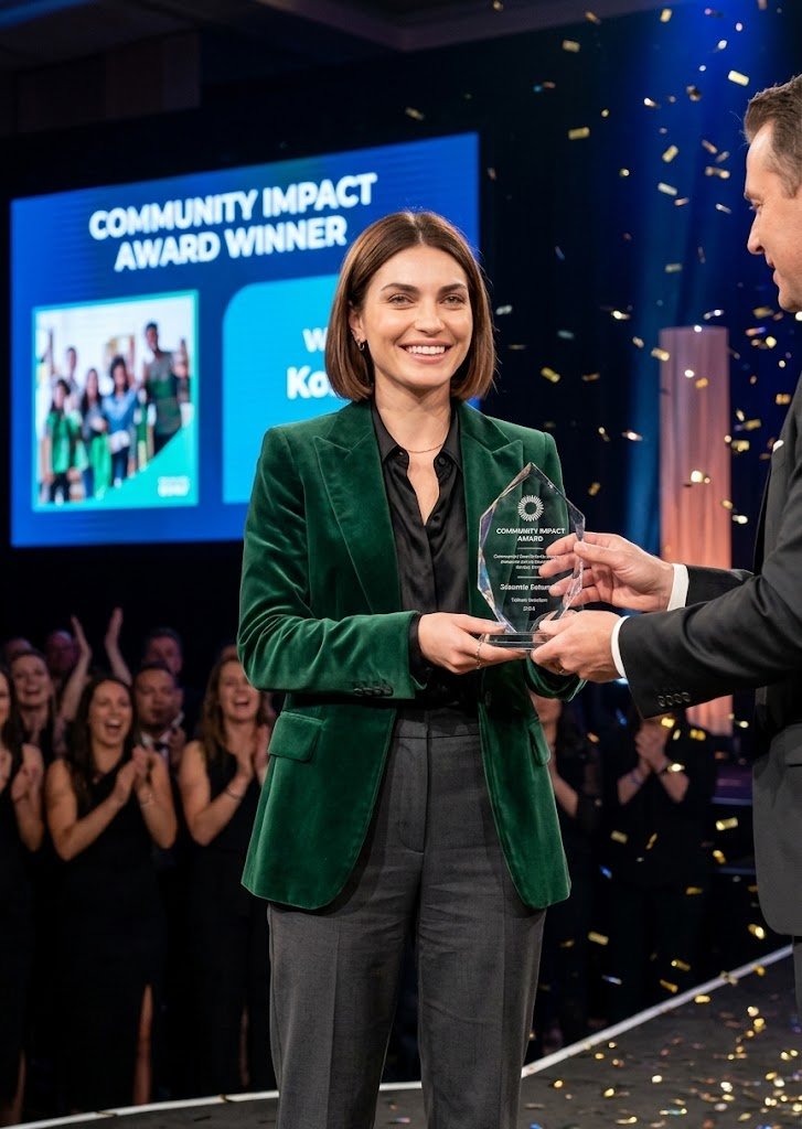 Nica Tasha accepting the Community Impact Award